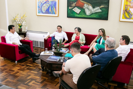 Imagem: Foto dos parlamentares e dos dirigentes da UFC sentados nos sofás do Gabinete da Reitoria