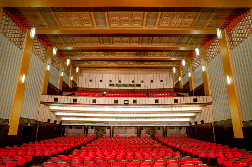 Imagem: foto de uma sala de teatro vista do palco. 